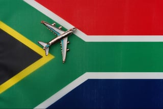 Airplane over South African flag travel