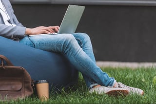 Teleworker using laptop while sitting on bean bag chair Teleworker using laptop while sitting on bean bag chair