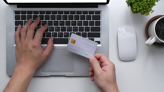 Hand Holding A Credit Card Paying Online