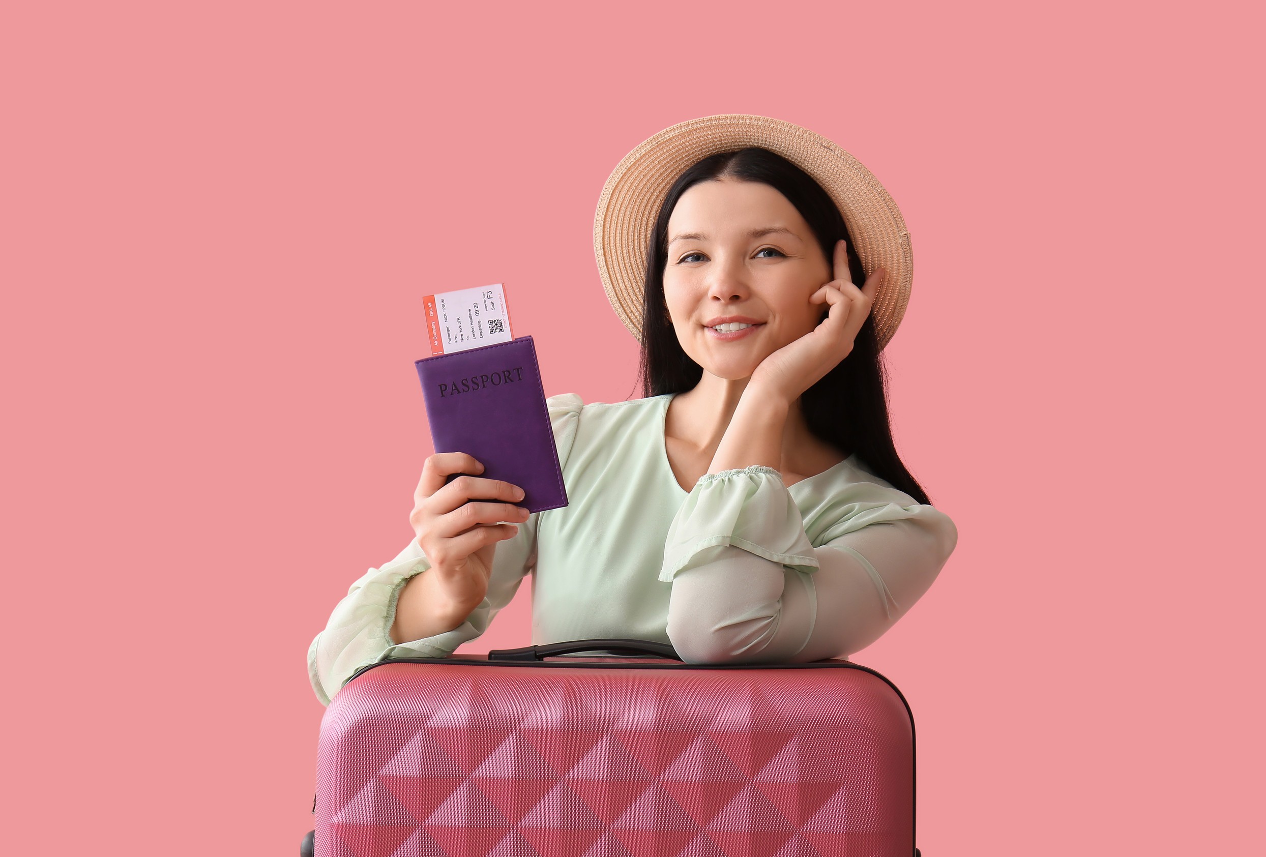 Beautiful Young Woman with Passport, Ticket, and Suitcase